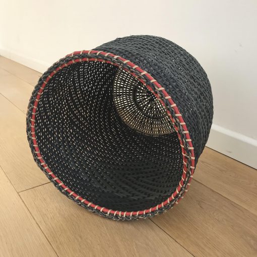 A black storage basket handwoven by Colombian native people